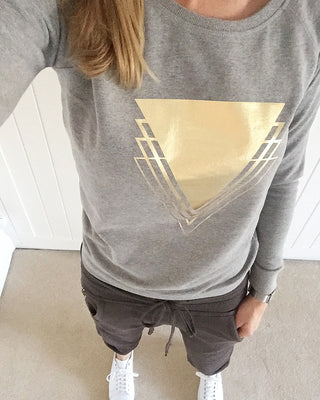 Metallic gold triangles on light grey sweat