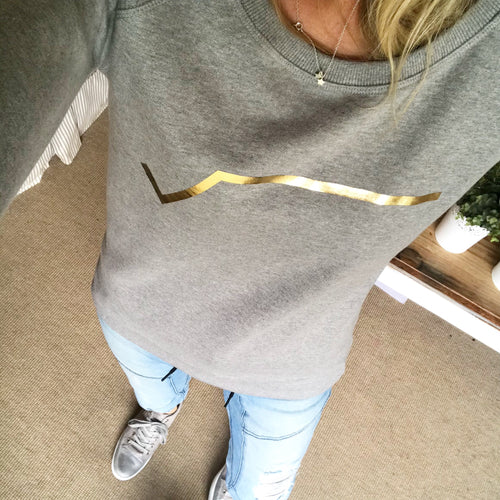 Gold diagonal stripe on light grey sweatshirt