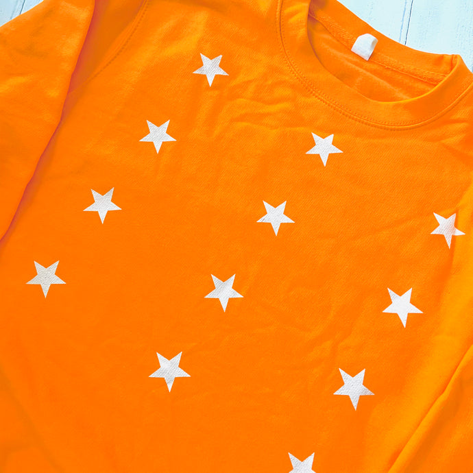 Little white stars on bright orange sweatshirt (medium, size 12-14)