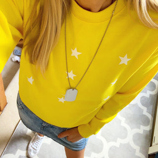 Little white stars on a bright yellow sweatshirt