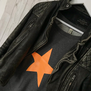 Neon orange star on dark grey sweat