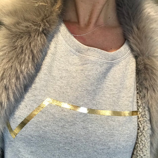 Gold diagonal stripe on light grey sweatshirt