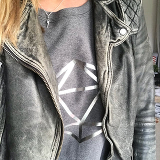Metallic silver octahedron on a dark grey sweat