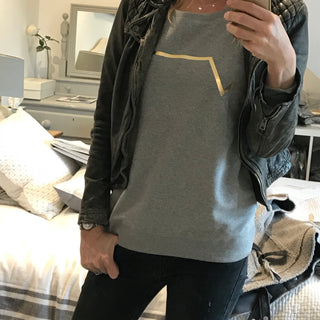 Gold diagonal stripe on light grey sweatshirt