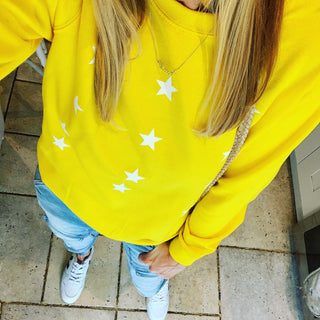 Little white stars on a bright yellow sweatshirt
